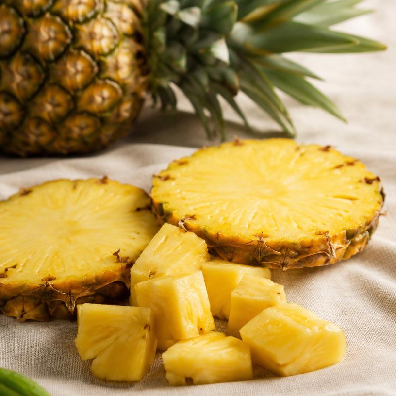 Fresh pineapple slices and cubes